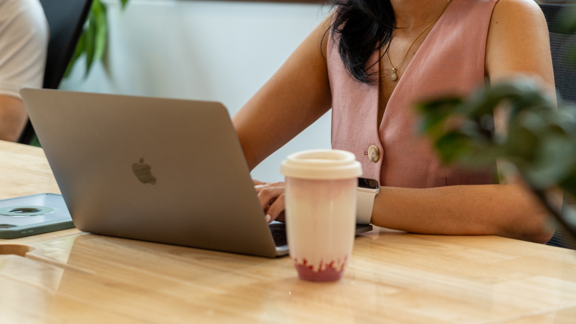 lady writing on computer with coffee