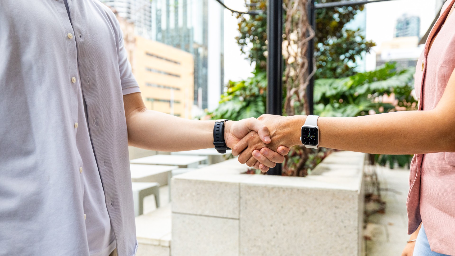 women and man shaking hands