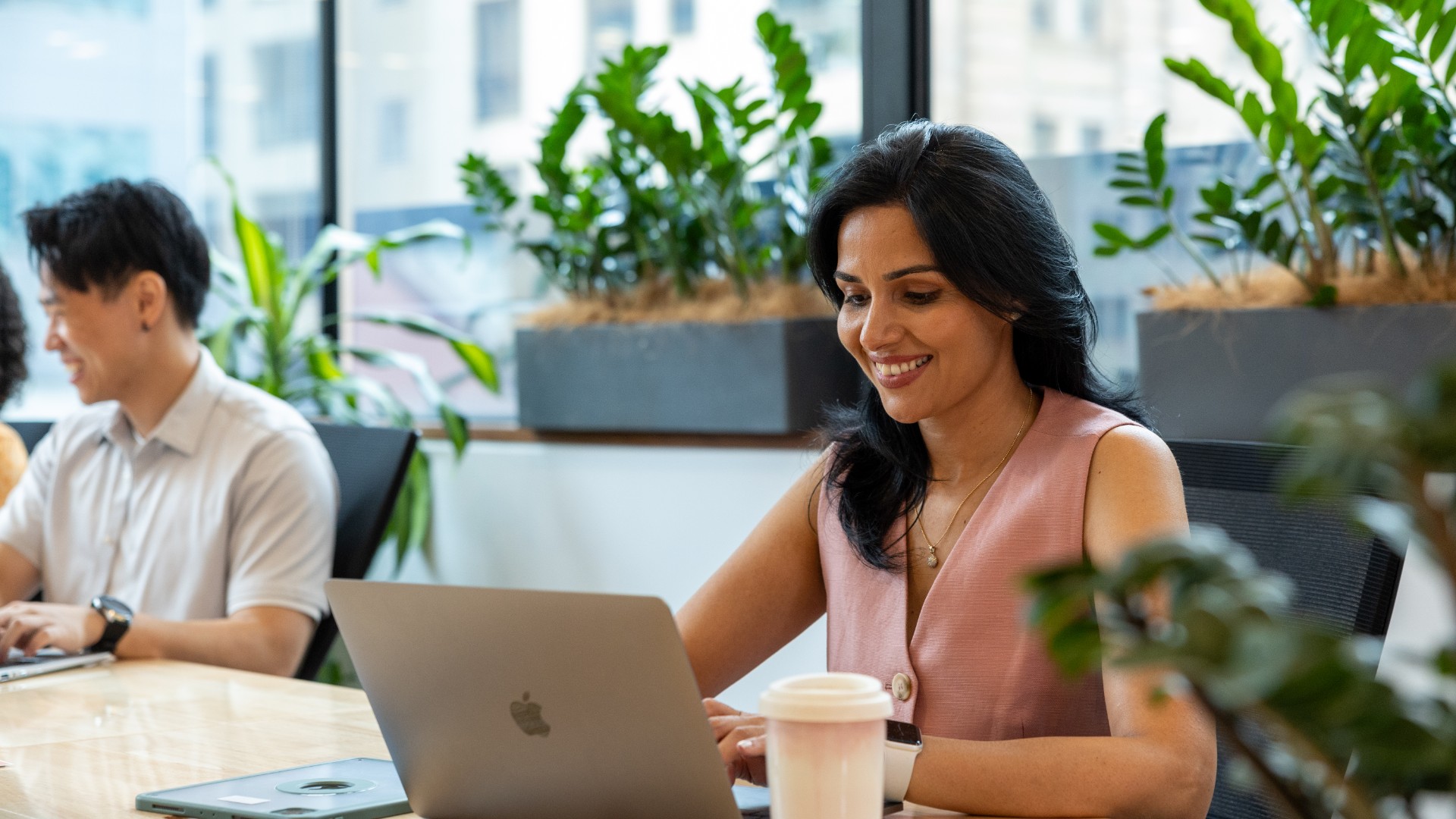 Women on computer at desk smiling