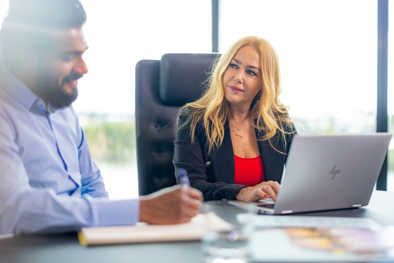 Man and woman talking in a conference room